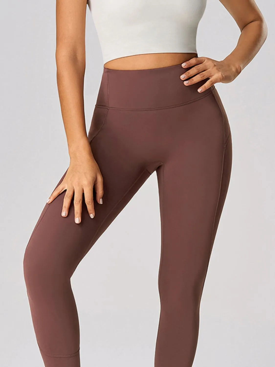 Brown leggings worn by a person on a light gray background