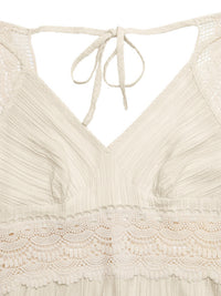 Close-up of a beige lace top with a tie detail on a white background