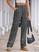 Person wearing gray cargo pants with a Prada handbag in an outdoor setting