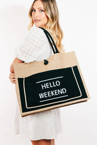 Woman holding a tote bag with 'Hello Weekend' text on a white background