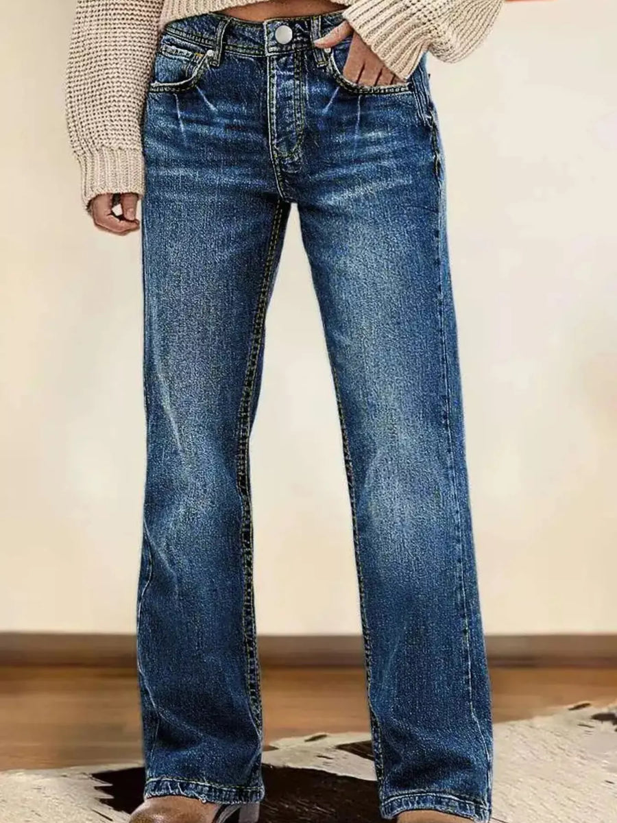 Blue jeans worn by a person on a neutral background
