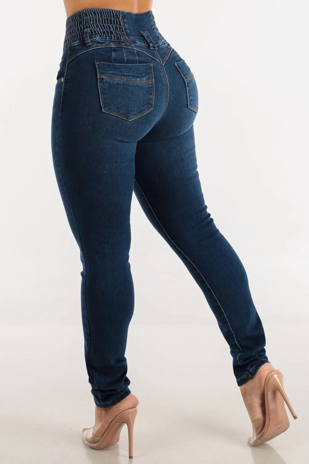 Blue jeans worn by a person on a white background