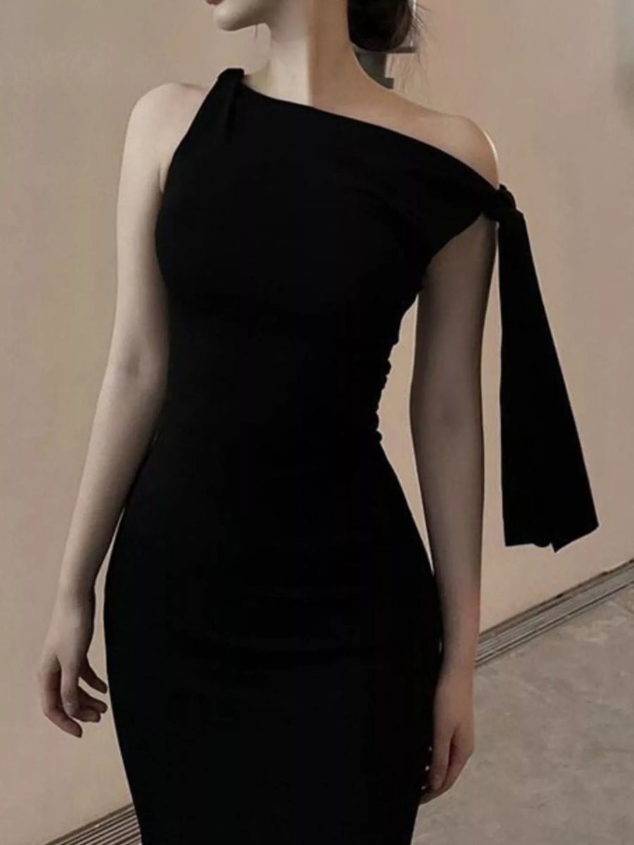 Black one-shoulder dress on a mannequin against a neutral background