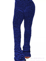 A close-up of a person's legs wearing textured, ribbed knit leggings in a deep royal blue color, shown against a plain white background.