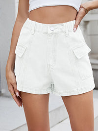 White denim shorts worn by a person on a neutral background