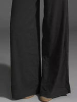 Black pants with a white stripe on a gray background