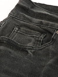 Close-up of black denim shorts with a focus on the pocket area.