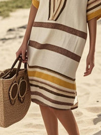Close up the bottom of the brown and beige striped dres