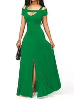 Green evening gown with cut-out shoulders and a high slit on a white background