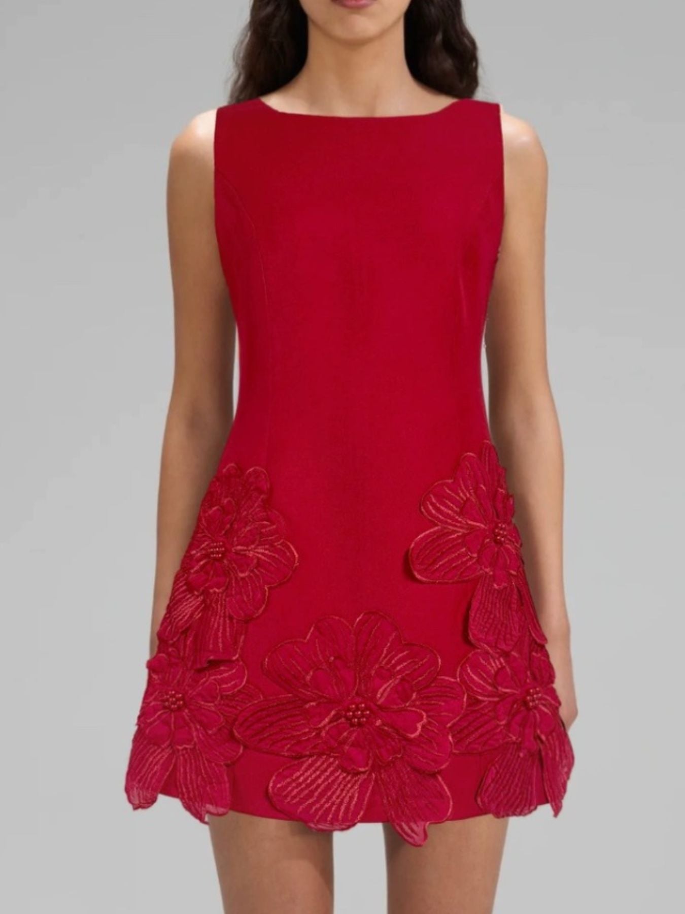 Red dress with floral details on a gray background