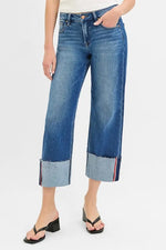 Person wearing blue jeans with a white background
