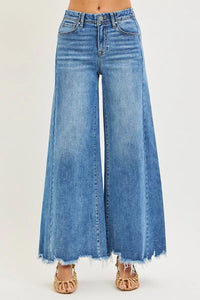Wide-leg blue jeans on a plain background