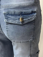 Close-up of a pocket on a pair of blue jeans with a button.