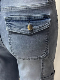 Close-up of a pocket on a pair of blue jeans with a button.