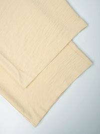 Beige fabric sheets on a light gray background