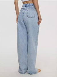 Light blue jeans worn by a person on a white background