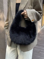 Person wearing a dark blue fur stole over a beige coat.