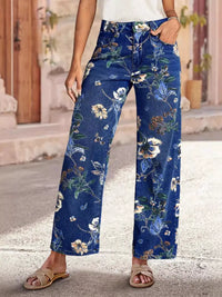 Person wearing blue floral pants standing outdoors.