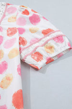 Baby leggings with watercolor heart pattern on a light gray background