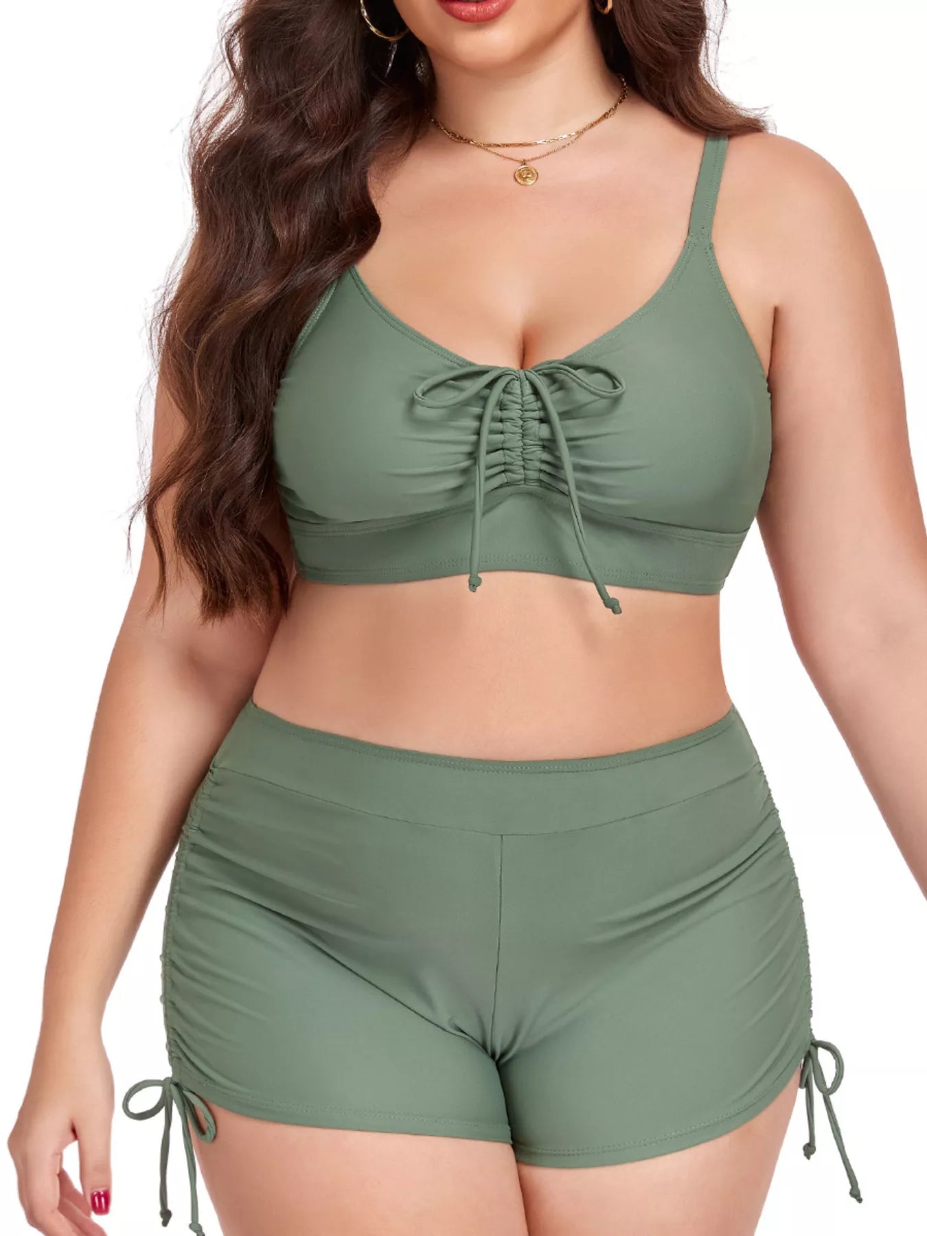 Woman wearing a green bikini set on a white background
