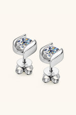 Silver earrings with clear gemstones on a white background