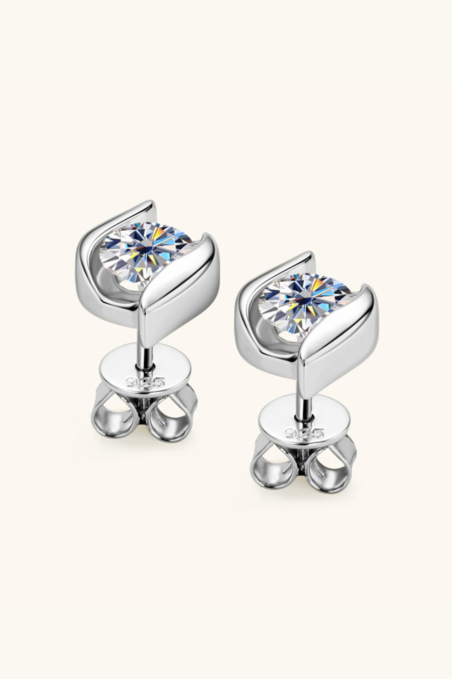Silver earrings with clear gemstones on a white background