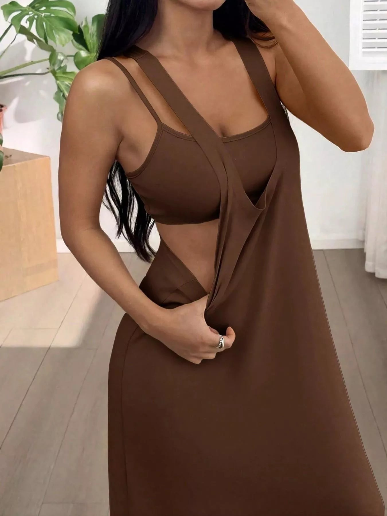 Woman wearing a brown dress in an indoor setting