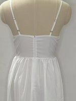 White nightgown on a mannequin against a plain background