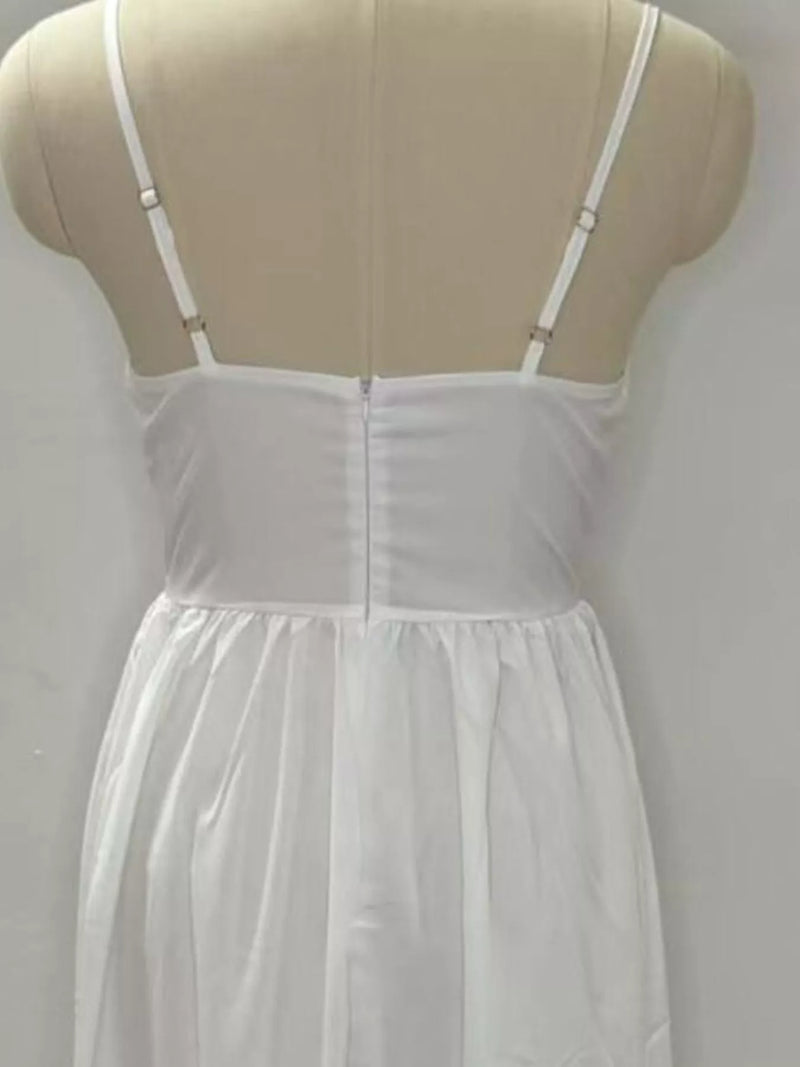 White nightgown on a mannequin against a plain background
