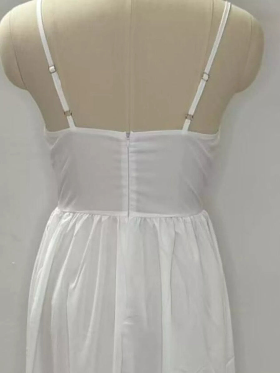 White nightgown on a mannequin against a plain background