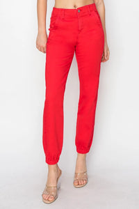 Red pants worn by a person on a white background