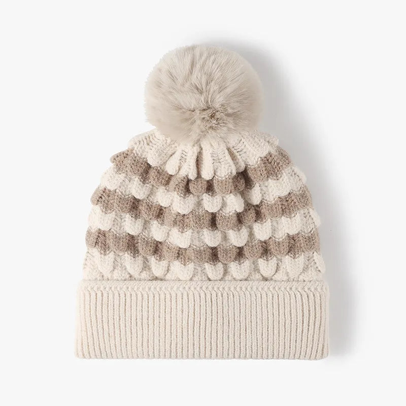 Knitted beanie with pom-pom on a white background