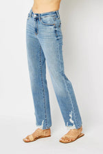 Light blue jeans worn by a person on a white background