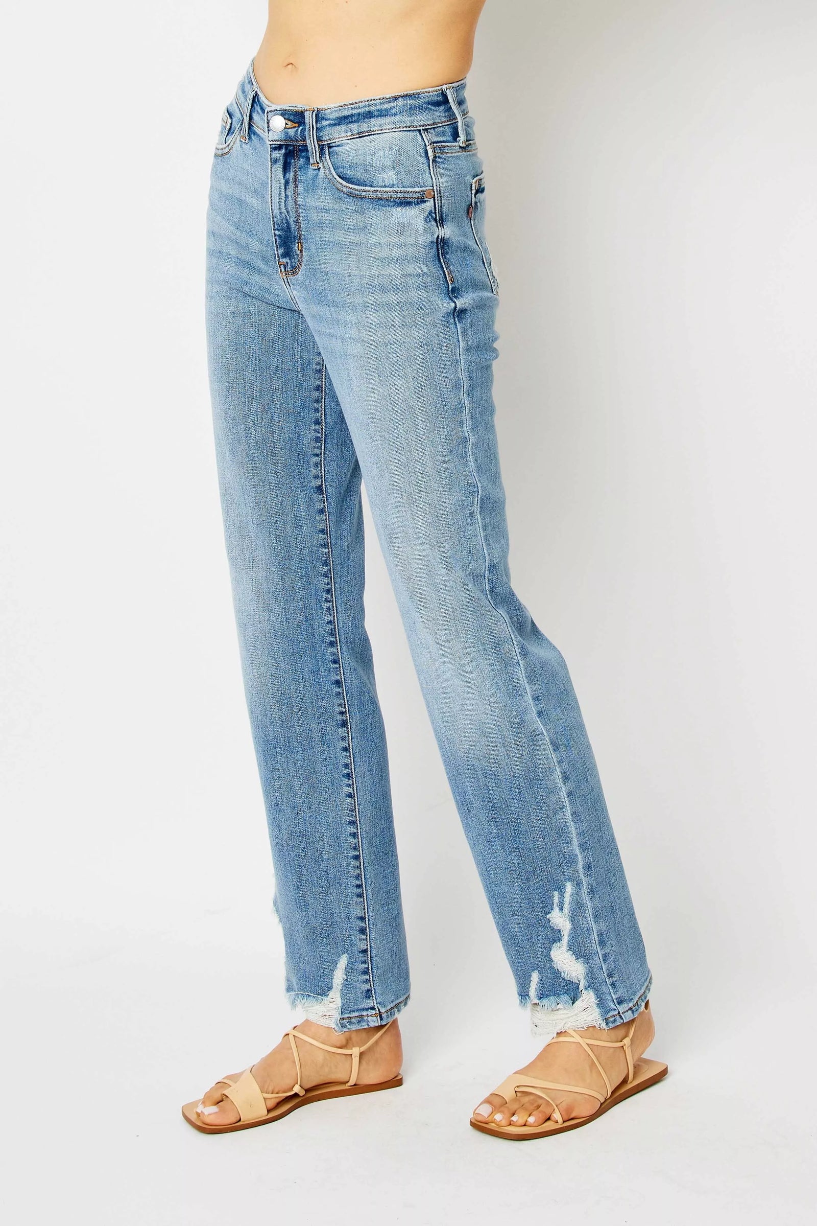 Light blue jeans worn by a person on a white background