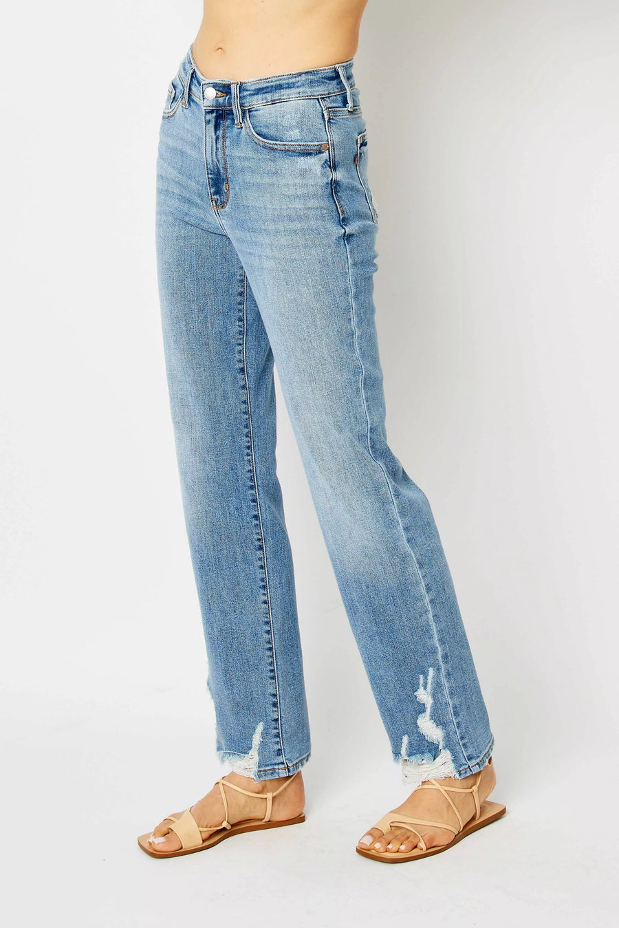 Light blue jeans worn by a person on a white background
