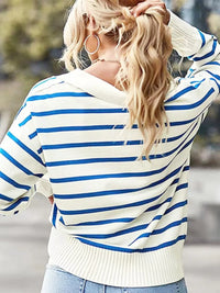 Person wearing a blue and white striped sweater with blurred background