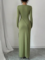 Green long-sleeve dress worn by a person against a plain background