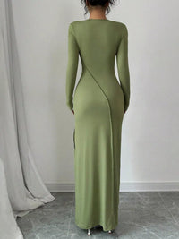 Green long-sleeve dress worn by a person against a plain background