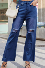 Person wearing blue jeans with a blurred background