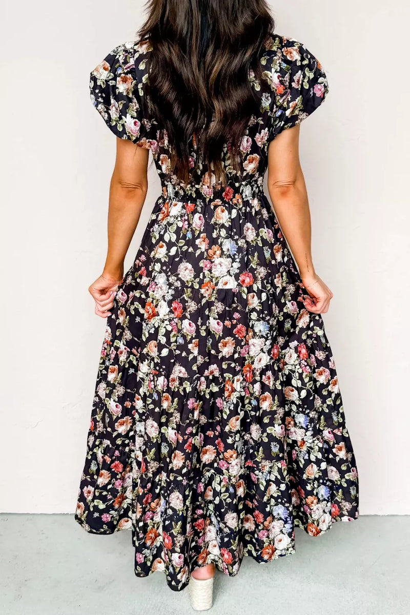 Woman wearing a floral dress with a plain background