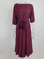 Maroon dress on a mannequin against a white background