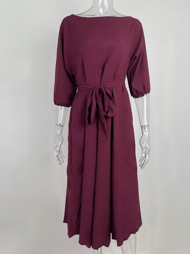 Maroon dress on a mannequin against a white background