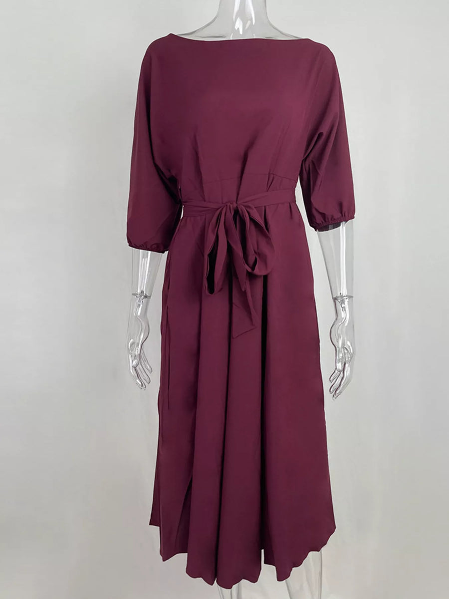Maroon dress on a mannequin against a white background