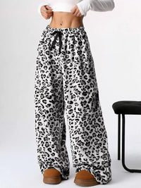 Leopard print wide-leg pants worn by a person on a white background