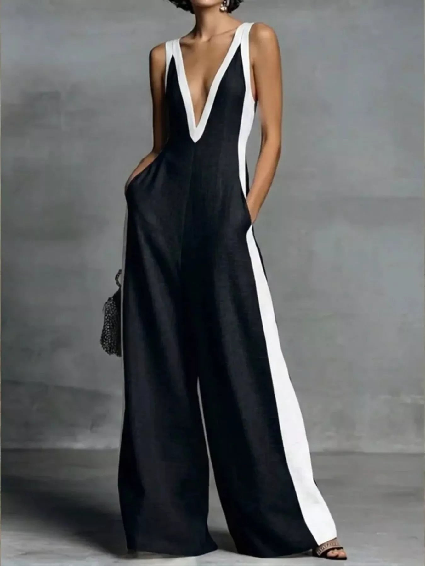 Black and white dress with a deep neckline on a gray background