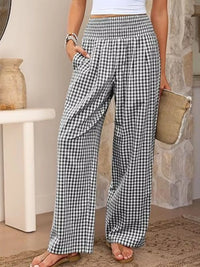 Person wearing black and white checkered pants in a casual setting.