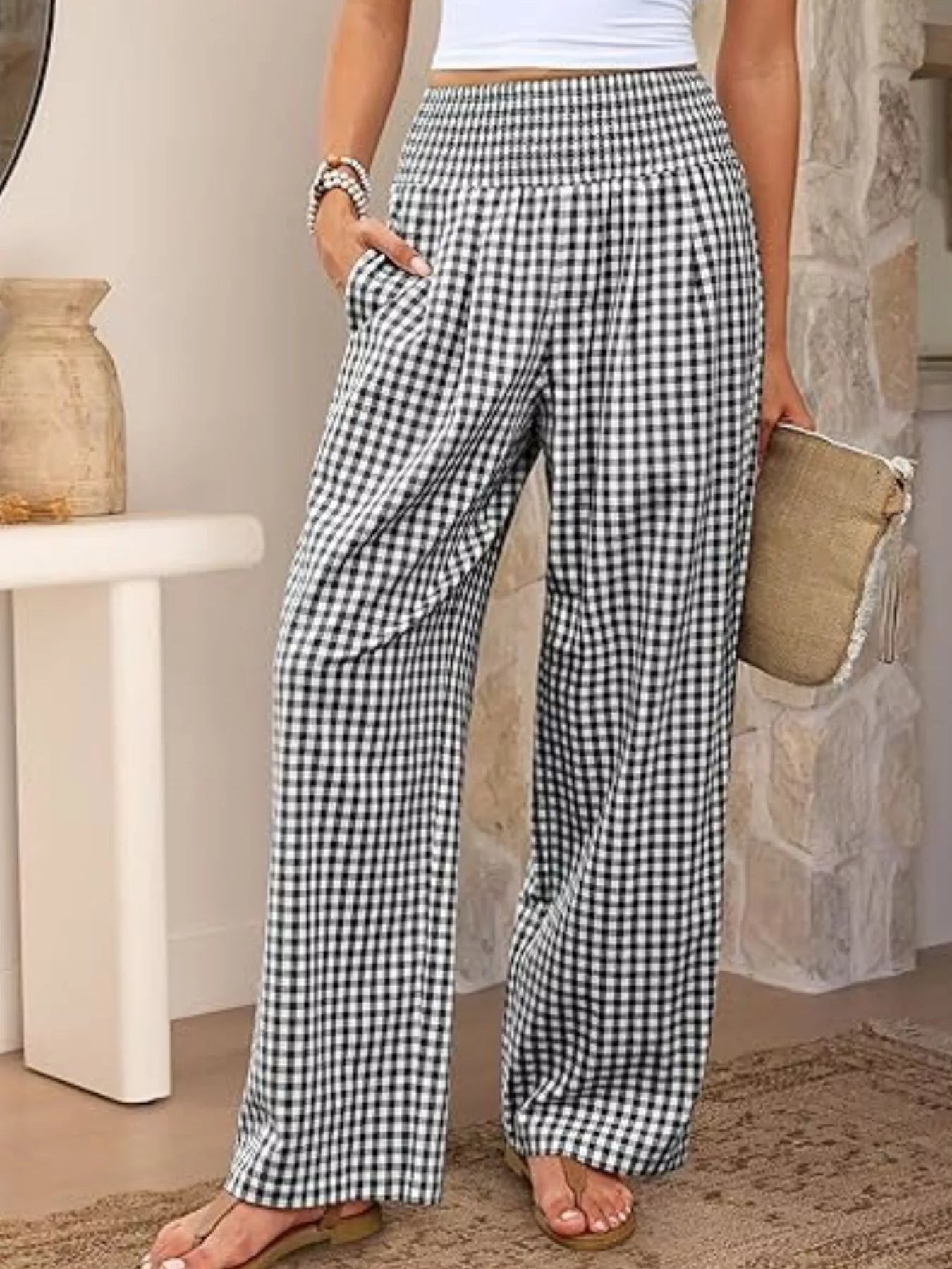 Person wearing black and white checkered pants in a casual setting.