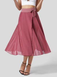 Mauve skirt with a white top on a plain background