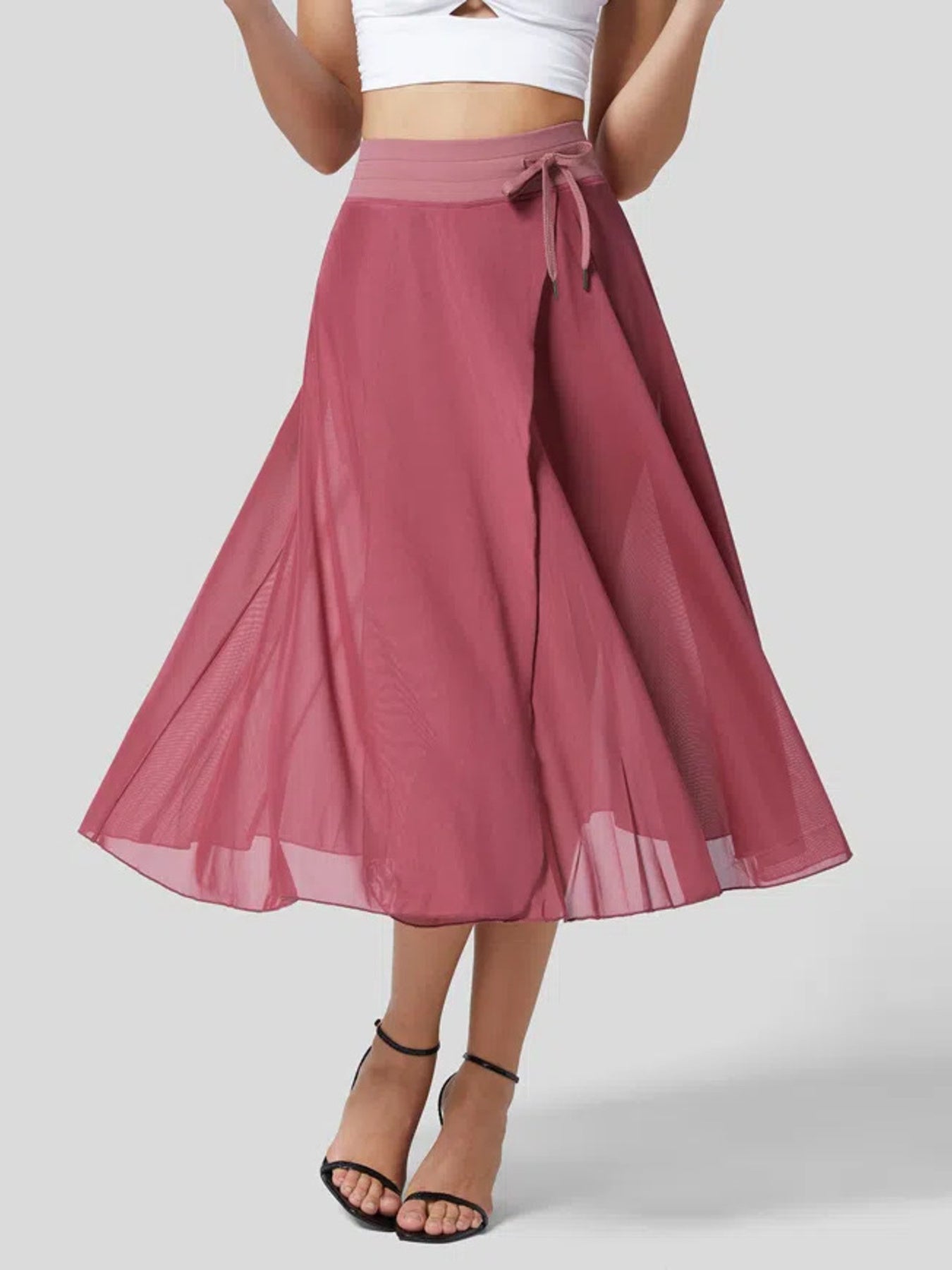 Mauve skirt with a white top on a plain background