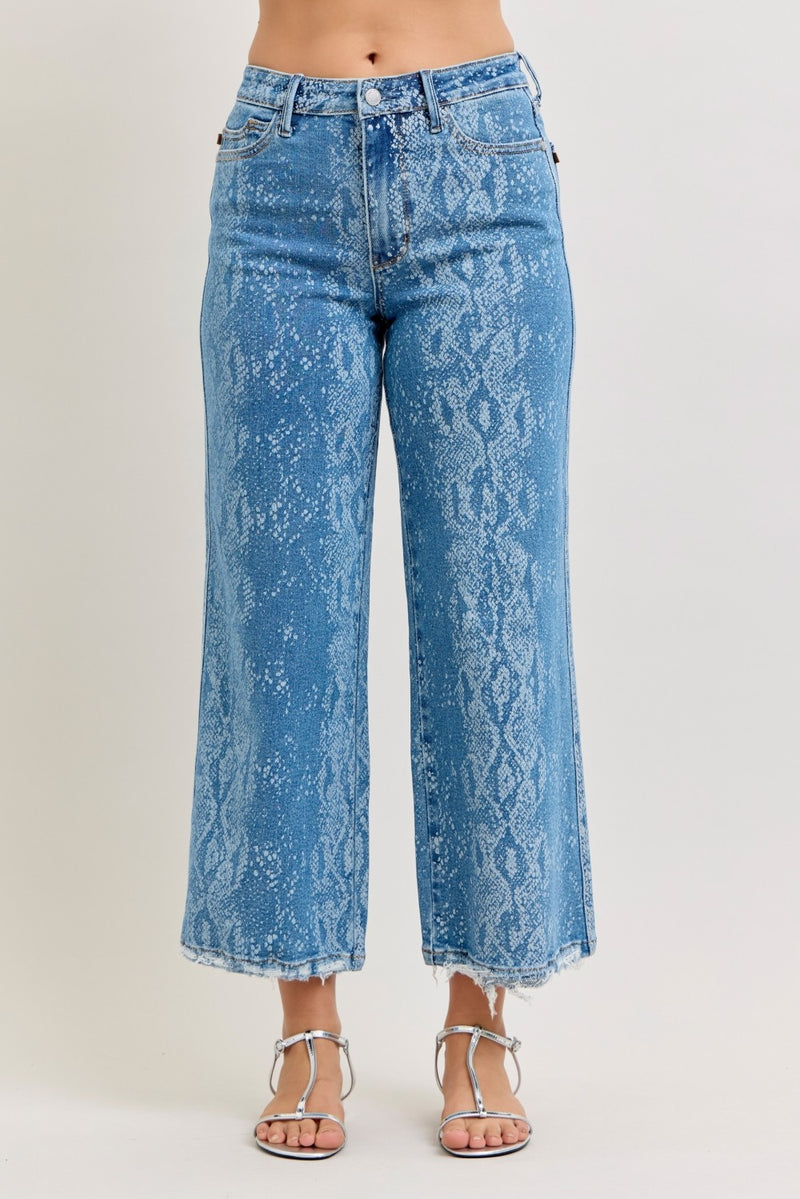 Blue acid-wash jeans worn by a person on a white background